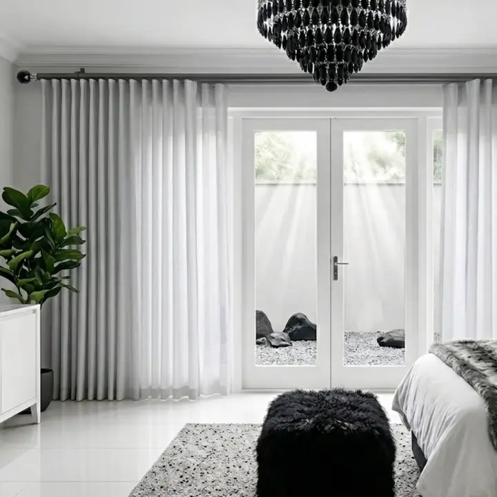 Gun metal 28mm double pole set with a decorative faceted crystal finial and matching hardware, shown in a modern interior.